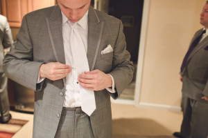 groom straightens tie