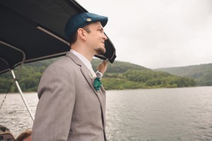wedding on a pontoon boat with groom smiling