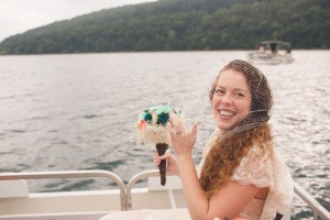 wedding on a pontoon boat with bride smiling