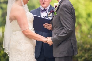 couple exchanges wedding rings at shade trees and evergreens photography