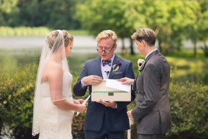 couple exchanges wedding rings at shade trees and evergreens photography