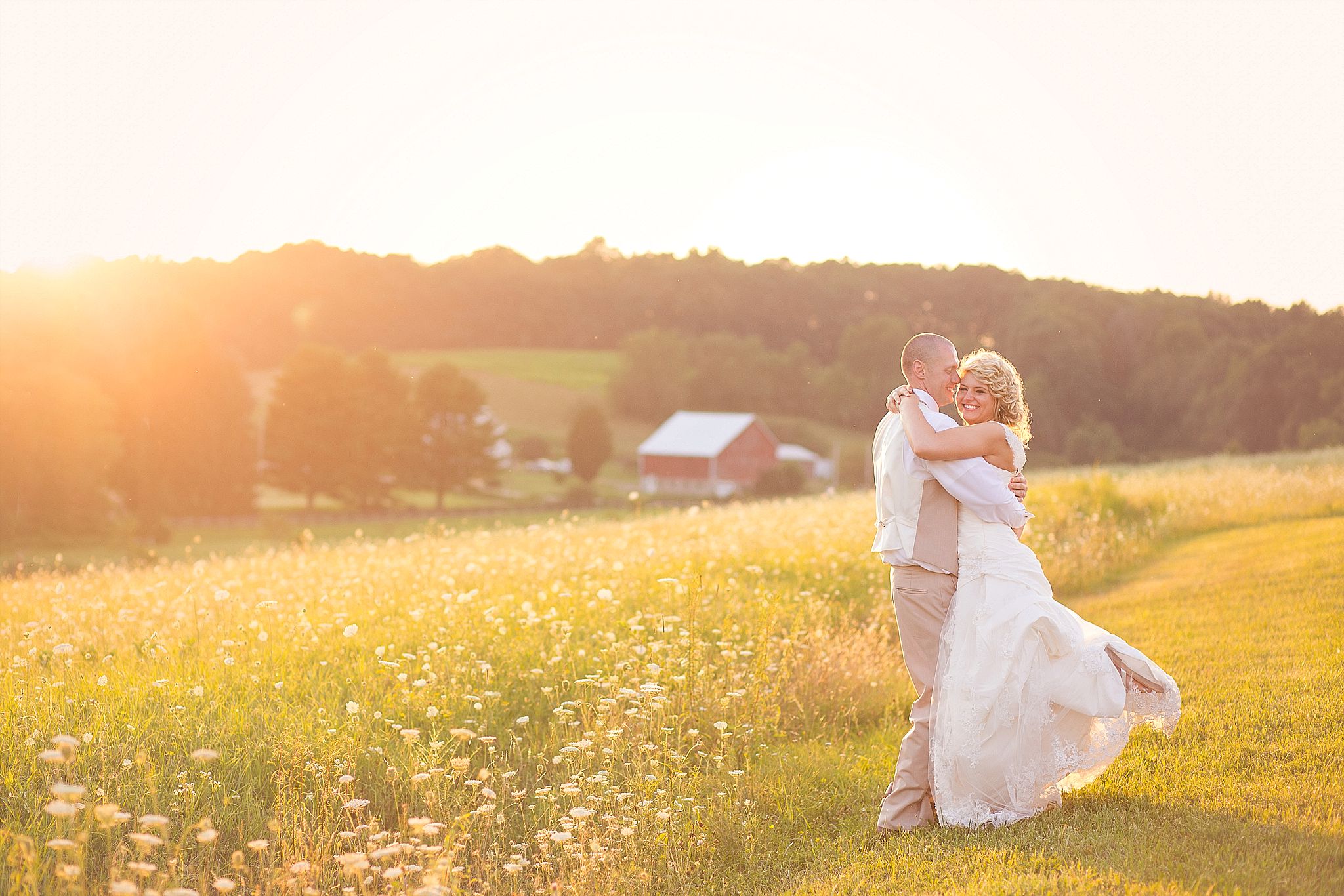 bride and groom with sunset and barn rustic photography