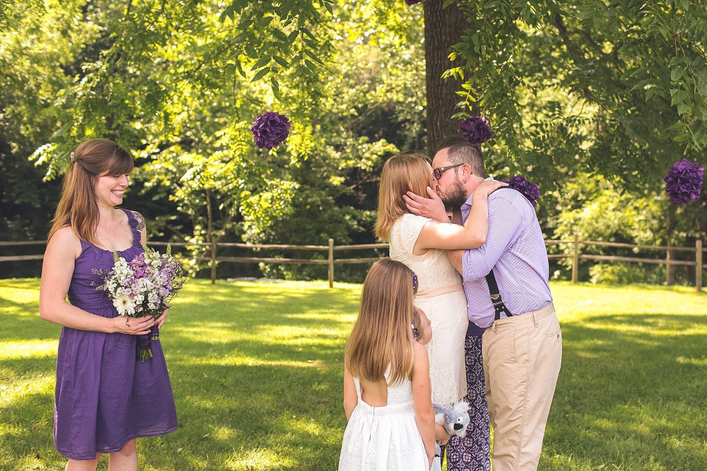 bride and groom first kiss under tree at outdoor dc wedding ceremony