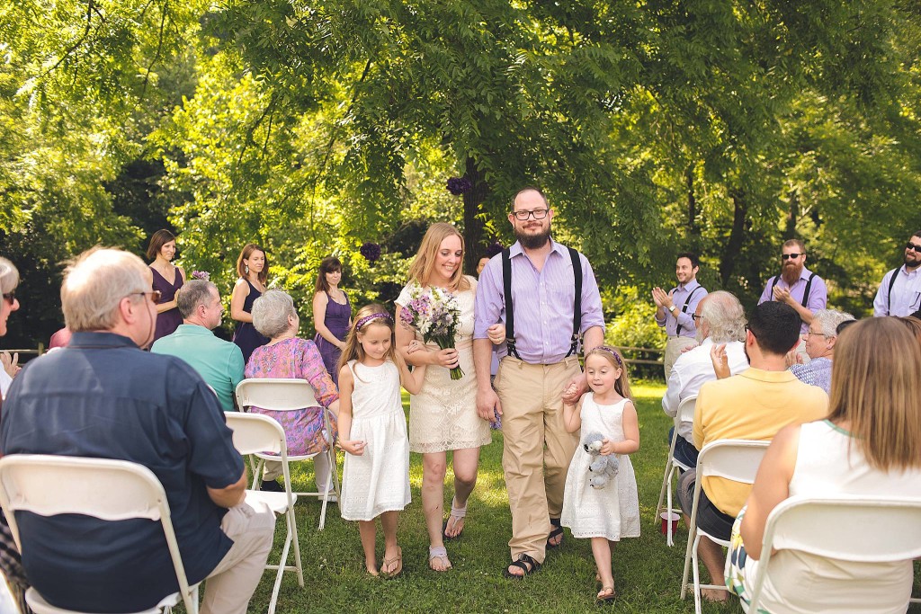 new family walks up aisle after dc outdoor wedding ceremony