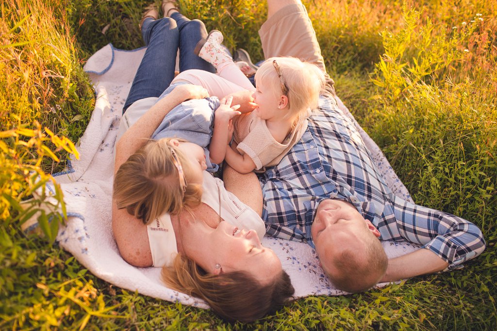 family snuggles in field during maryland photography session