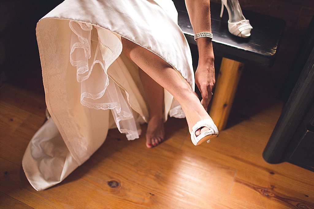 bride gets shoes on at baltimore wedding