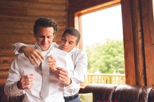 dc wedding photographer captures best man helps groom get tie on