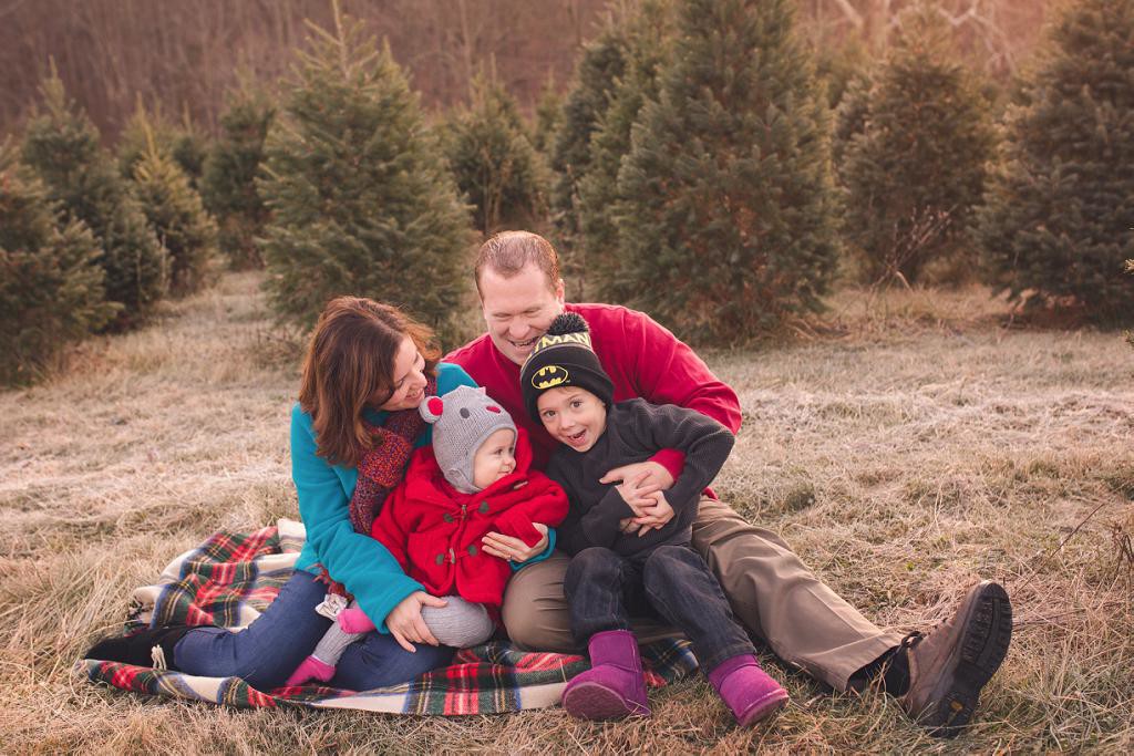 family at christmas tree farm for photography session