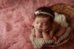 cumberland newborn photographer poses baby in basket